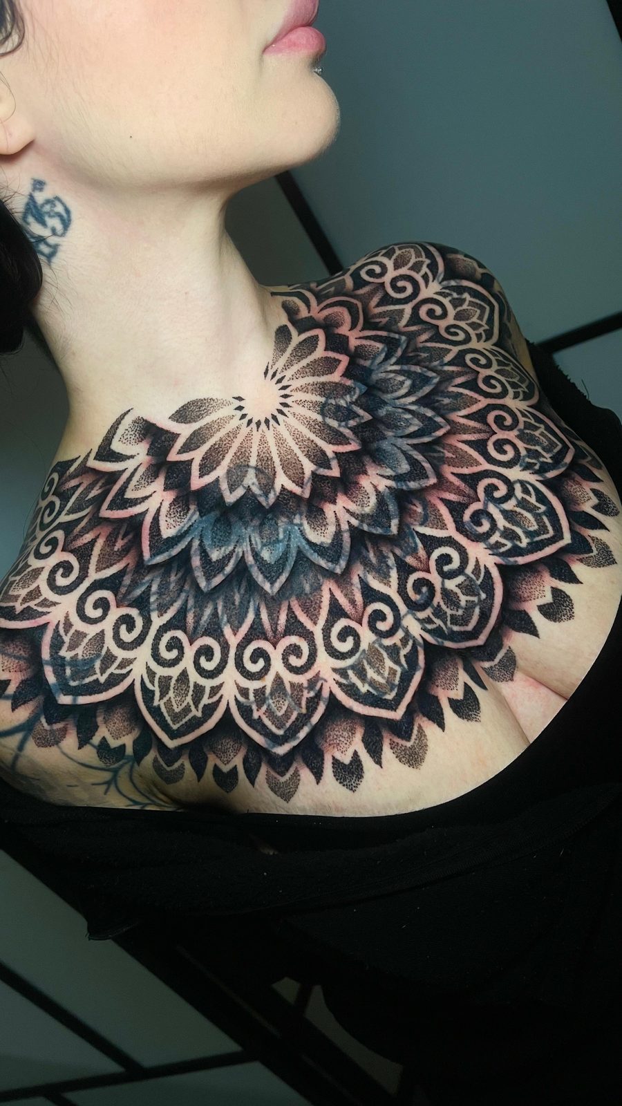 Symmetrical dotwork mandala tattoo across the chest and shoulder by Scotty Massa